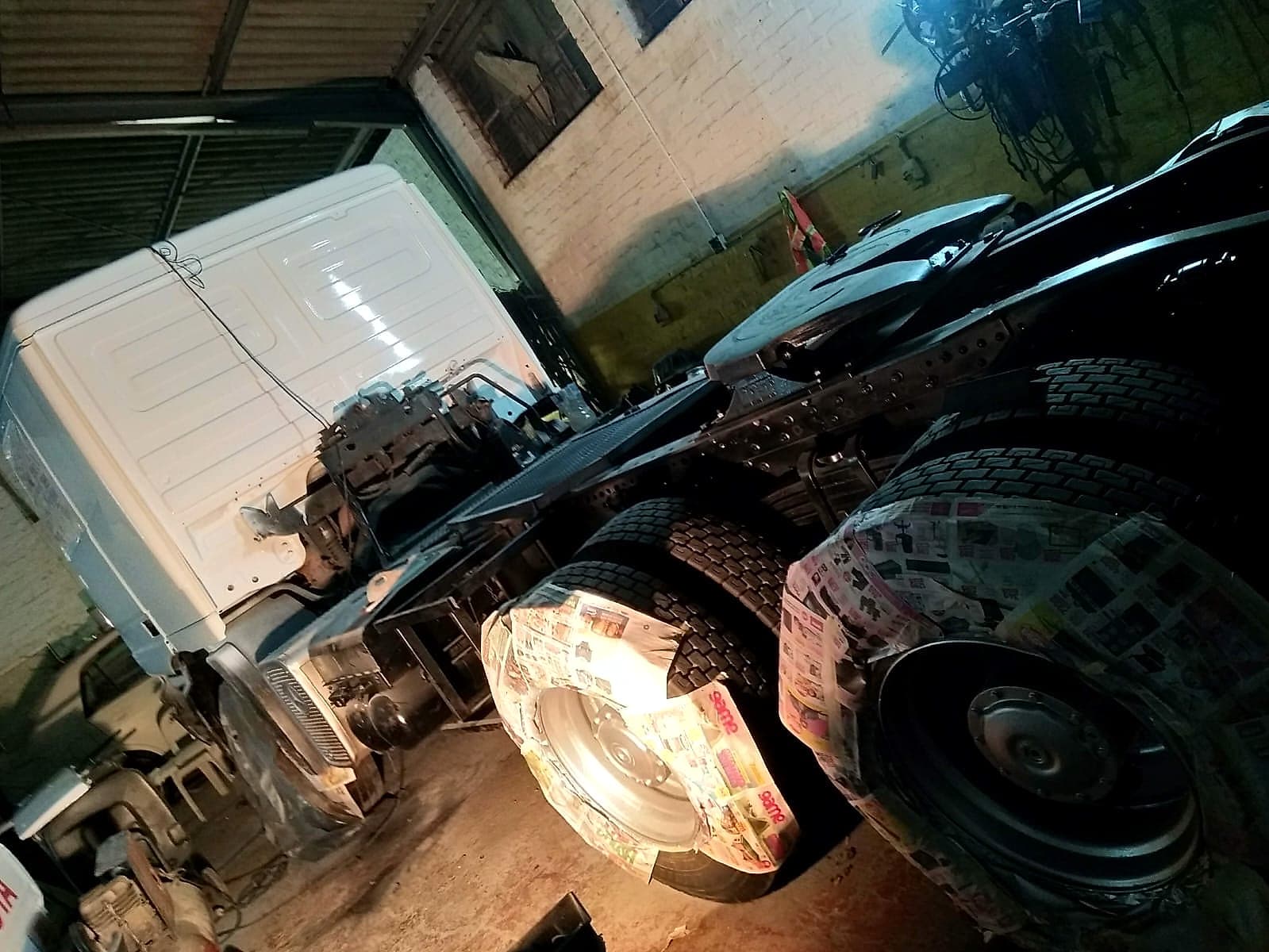 Commercial truck masked and prepped for respray in the workshop